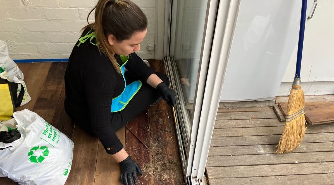 Woman cleaning dust and debris